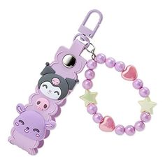 a key chain with an animal and star charm on it's side, attached to a purple beaded lanyard