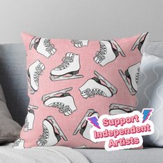 a pink pillow with black and white ice skates on it, that says support independent artists