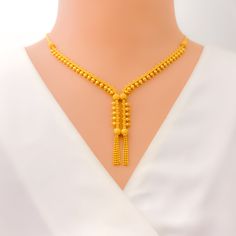 This Impeccable Unique Dangling Necklace Set, crafted in 22k yellow gold, is a masterpiece of elegance and design. Weighing 20.1 grams, the necklace features a 16-inch length with a 2-inch drop, creating a graceful drape that highlights its intricate craftsmanship. The luxurious yellow gold finish adds a radiant glow, while the lobster lock ensures a secure fit. The matching 1.5-inch earrings with push-back posts perfectly complement the necklace, making this set an exquisite choice for those who appreciate distinctive, high-quality jewelry. Ideal for special occasions, this set adds a touch of sophistication to any ensemble. PRODUCT DETAILS Gold Purity(karat): 22k Gold Weight(grams): 20.1 Item Finish: Yellow Gold Necklace Length: 16" Drop Length: 2" Lock Style: Lobster Lock Matching Earri Formal Yellow 22k Gold Chain Necklace, Elegant Yellow Chain Necklace For Formal Events, Elegant Long Yellow Gold Temple Necklace, Elegant 22k Gold Yellow Chain Necklace, Elegant Gold Plated Yellow Temple Necklace, Elegant 22k Gold Temple Necklace In Yellow, Elegant 22k Gold Chain Necklace, Elegant 22k Gold Yellow Temple Necklace, Elegant Yellow 22k Gold Temple Necklace