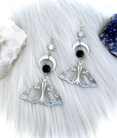 💜PRE-ORDER 2-3 week shipping! 💜Lovely celestial moth butterfly dangle earrings made with stainless steel silver charms, black tourmaline crystal beads, sun bursts and crescent moon charms. Cottagecore, mystical, boho spiritual dangle jewelry drop crystal earrings. Black tourmaline is a healing crystal which is known to help with anxiety relief, calming fears, adding to self-confidence and inner peace. It is helpful for the body, mind and spirit.  It has added benefits of soothing and bringing balance to your physical body as well as cleansing your aura and protecting you from negative energy. ♡ The moth is a representation of personal transformation and change. It symbolizes growth, inner wisdom, psychic abilities and freedom. When paired together, the moth and black tourmaline are power Boho Spiritual, Cottagecore Grunge, Black Tourmaline Crystal, Luna Moth, Magical Jewelry, Butterfly Jewelry, Fantasy Jewelry, Etsy Earrings Dangle, Dream Jewelry