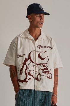 ‘Our Specialty’ is combining aesthetic and quality. With handmade chain stitched embroidery and a cropped cut, this piece is a must have. Note - Each piece is carefully hand stitched, so all garments will have slight variations, making every piece unique. Featuring: - 100% cotton - Cuban collar- Cropped body - Chain stitched body Colour: Off White + Brown Embroidery. Care: - Cold hand or machine wash. Do not tumble dry. Cool iron Sizing: Oversized. Our model is wearing a size medium shirt he is 186cm (6’1”) Crop Dress Shirt, Goa Outfits, Cuban Shirt, Fashion Souls, Brown Embroidery, Cut Off Shirt, Fancy Shirt, Chain Stitch Embroidery