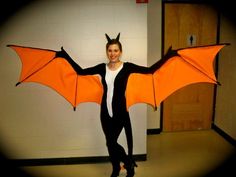 a woman wearing a costume made to look like a bat