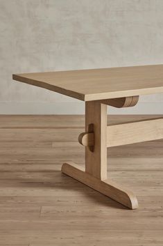 a wooden table sitting on top of a hard wood floor