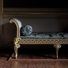 an ornate gold and silver bench in a dark room