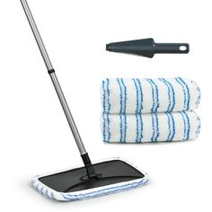 the mop is next to two towels and a cleaning brush on a white background