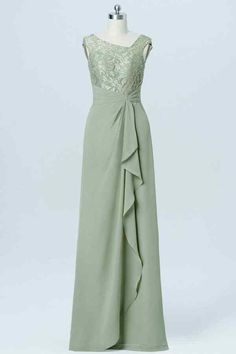 a dress on a mannequin with lace and ruffles in sage green