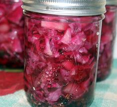 red onions are in a jar with water on the top and some other things inside