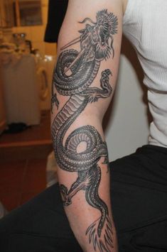 a man with a dragon tattoo on his arm