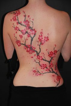 the back of a woman's body with flowers painted on it