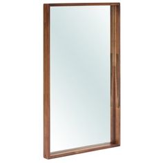 a wooden mirror hanging on the wall