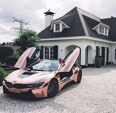 a pink car parked in front of a house