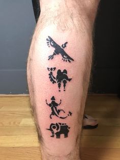 a man's leg with tattoos on it and an image of animals in the middle