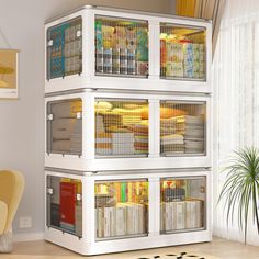 a white bookcase filled with lots of books in a living room next to a window