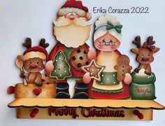 a christmas scene with santa claus, reindeers and other holiday decorations on a shelf