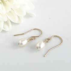 Simple, dainty classic pearl earrings are the perfect accessory to finish your look. These dainty earrings are perfect wedding jewelry for brides or bridesmaids. The total drop on these earrings is about 3/4 inches. These earrings are available in your choice of 14k rose gold fill, sterling silver or 14k gold fill. Your new earrings will arrive in a complimentary gift box. Link to matching necklace https://www.etsy.com/listing/705383905/single-pearl-necklace-tiny-oval-pearl More pearl jewelry ht Dainty Pearl White Bridal Earrings, Classic Pearl Bridal Earrings With Ear Wire, Elegant Pearl Earrings For Bridesmaid Gift, Dainty Drop Pearl Earrings For Bridesmaids, Classic Pearl Drop Bridal Earrings For Bridesmaid Gift, Minimalist Hypoallergenic Teardrop Earrings For Wedding, Gold Delicate Pearl Earrings For Bridesmaid, Classic Pearl Earrings With Ear Wire For Weddings, Delicate Pearl Earrings For Bridesmaid Gift