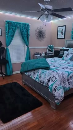 a bed room with a neatly made bed and a ceiling fan