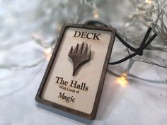 a christmas ornament with the words deck, the hall's what ends of magic on it