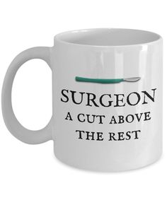 a white coffee mug with the words surgeon, a cut above the rest on it