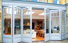 an open door leading into a living room and dining room with french doors on both sides