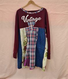 "Upcycled sweatshirt tunic, long sleeved, size UK22/EU 50/USA 20 Width at underarm/top of \"skirt\" of tunic 48\"/122cm. This part of the garment is made of woven fabrics, so won't stretch. Flares out from this point so width at hipline is around 57\"/144cm Uneven hem; shortest length at back is 35\"/89cm Top of tunic is an upcycled sweatshirt; \"skirt\" of tunic is made from woven fabrics - upcycled shirts, denim and household linens. Wash at 30 degrees; tumble dry at appropriate temperature. N Casual Long Sleeve Patchwork Sweater, Long Sleeve Patchwork Sweater For Fall, Retro Patchwork Sweatshirt For Fall, Long Sleeve Patchwork Sweatshirt For Spring, Long Sleeve Patchwork Tops For Loungewear, Spring Long Sleeve Patchwork Sweatshirt, Fall Layering Long Sleeve Tunic, Long Sleeve Patchwork Sweatshirt For Fall, Oversized Patchwork Tops For Fall