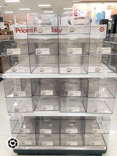 the display case is full of clear plastic boxes with price tags on them and labels for each item