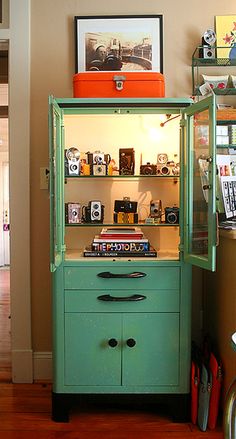 a green cabinet sitting in the corner of a room