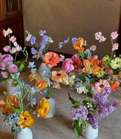 several vases filled with different types of flowers