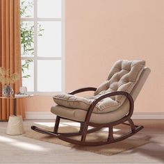 a rocking chair in a living room next to a window with curtains on the windowsill