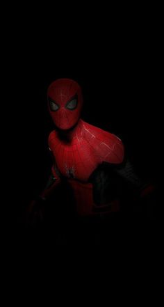 a spider man is standing in the dark