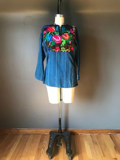 Casual Embroidered Denim Blouse, Folk Style Tops For Fall Festival, Embroidered Blue Denim Blouse, Blue Embroidered Denim Blouse, Blue Denim Embroidered Blouse, Indigo Long Sleeve Bohemian Top, Indigo Cotton Top With Floral Embroidery, Traditional Blue Tops For Fall, Indigo Cotton Tops With Floral Embroidery