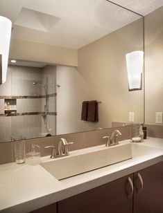 a bathroom with two sinks and a large mirror