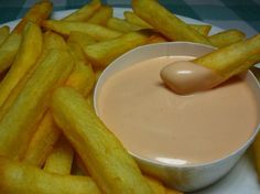 french fries with dipping sauce in a white bowl