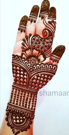 the hand is decorated with henna designs