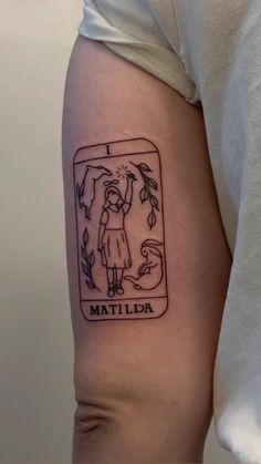 a woman with a tattoo on her arm holding an umbrella and the words matilda written in it