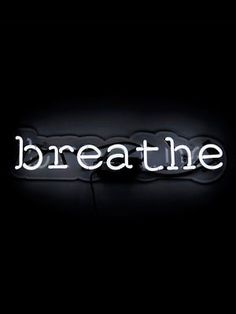 the word breathe is lit up in white letters on a black background with a shadow