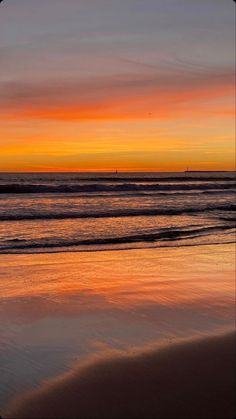 an orange and yellow sunset over the ocean