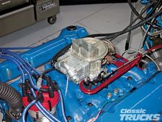 an image of a blue car engine with wires attached to the front and rear end