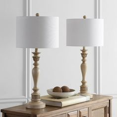 two lamps sitting on top of a wooden table