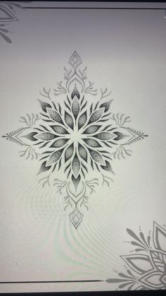 a drawing of a snowflake in black and white on a sheet of paper