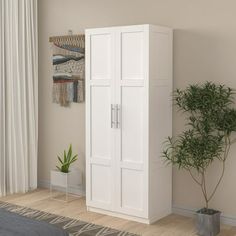 a tall white cabinet next to a potted plant in the corner of a room