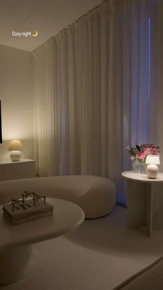 a living room filled with furniture and a flat screen tv sitting on top of a wall