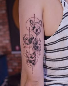 a woman with a tattoo on her arm has three dogs in the shape of a heart