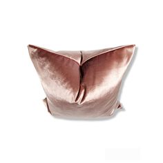 a pink velvet pillow on a white background, with the back half turned to show it's large square shape