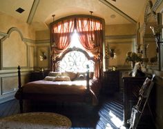 a bedroom with a large bed and lots of windows