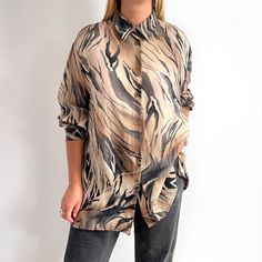 Gorgeous, neutral ladies shirt in beige brown and grey black tiger stripe print. It has a straight, relaxed shape, brown buttons, long sleeves, side slits and a straight collar. It is made from pure cupro (also called 'vegan silk'), which is super soft, smooth and silky to touch. Beautiful shirt for wearing on its own or over another top. Made by Gina G. 100% cupro. Large size, labelled as 50. Works really well as oversized for Medium sizes, too. Measurements when laid flat are: Pit to pit: 68cm Casual Long Sleeve Tiger Print Tops, Chic Relaxed Fit Brown Shirt, Chic Brown Relaxed Fit Shirt, Chic Brown Shirt With Relaxed Fit, Trendy Long Sleeve Tiger Print Tops, Black Tigers, Tiger Print, Stripe Print, Womens Clothing Tops