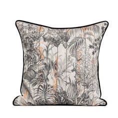 an orange and black pillow with tropical plants on the front, along with white background