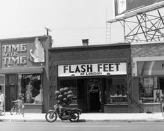 a black and white photo of an old fashion store