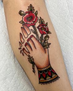 a close up of a person's foot with tattoos on it and flowers in the middle