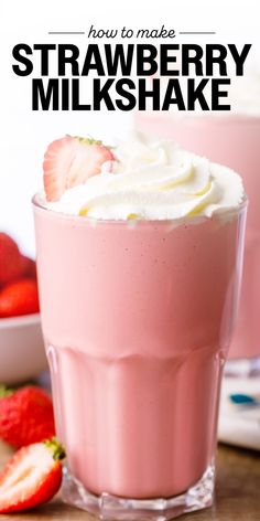 strawberry milkshake with whipped cream and strawberries in the background