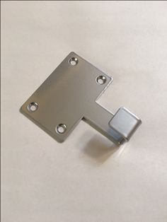 an image of a metal object on a white surface with some holes in the middle